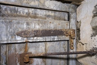 Interior. Ground floor. Milling area. Detail of original door hinge and door stop.