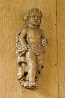 Interior.  Detail of carved wooden 'cherub' on panelling in Ante-Room.