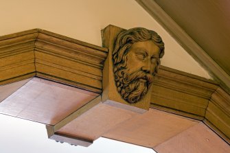Interior.  Detail of carved wooden head in the Ante-Room.
