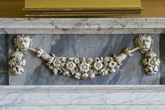 Interior.  Detail of marble carving on white marble fireplace in Blue Room.