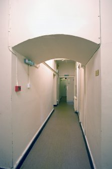 Interior.  Basement corridor, arch through William Burn extension.