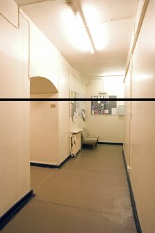 Interior.  Basement corridor showing passageway through original house wall.