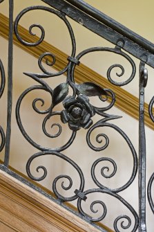 Interior.  Detail of staircase balustrade, rose motif.