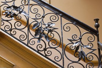 Interior.  Detail of staircase balustrade, thistle, oak and tulip motifs.