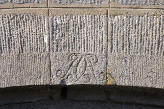 Detail.  Carved stone above stable entrance 'A A'