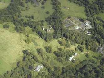 Oblique aerial view centred on the house and walled garden with the earthwork and Blairesk Hall in foreground, taken from the SW.