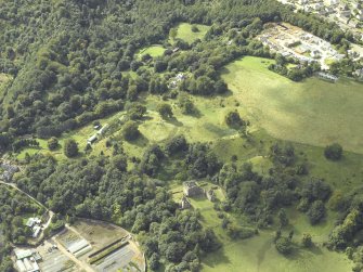 Oblique aerial view centred on the house and walled garden with the earthwork and Blairesk Hall adjacent, taken from the NE.