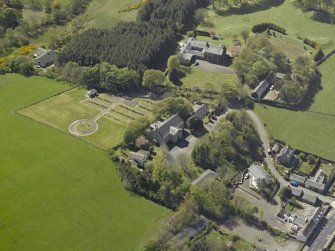 Oblique aerial view centred on Glebe house with the church adjacent, taken from the NE.