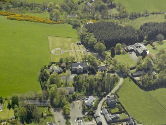 Oblique aerial view centred on Glebe house with the church adjacent, taken from the NNW.