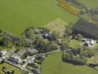 Oblique aerial view centred on Glebe house with the church adjacent, taken from the NW.