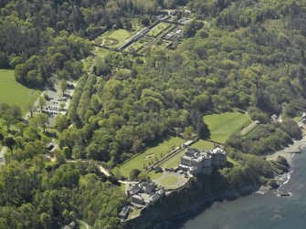 Oblique aerial view centred on the Castle with the stables & walled garden adjacent, taken from the NNE.