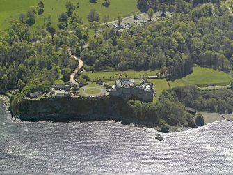 Oblique aerial view centred on the Castle with the stable block adjacent, taken from the NW.