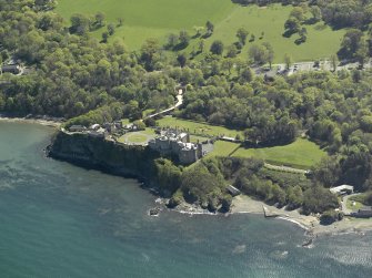 Oblique aerial view centred on the Castle with the stable block adjacent, taken from the NW.