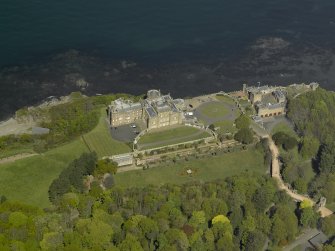 Oblique aerial view centred on the Castle with the stable block adjacent, taken from the S.