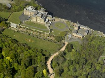 Oblique aerial view centred on the Castle with the stable block and ruined arch adjacent, taken from the SSE.