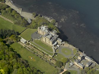 Oblique aerial view centred on the Castle with the stable block adjacent, taken from the SE.