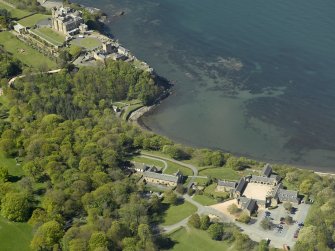 Oblique aerial view centred on the Home Farm with the Castle and stable block adjacent, taken from the SE.