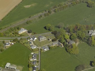 Oblique aerial view centred on the Church with the manse adjacent, taken from the SW.