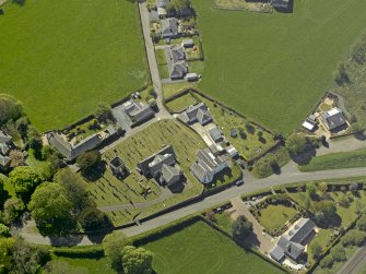 Oblique aerial view centred on the Church with the manse adjacent, taken from the NE.