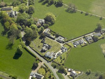 Oblique aerial view centred on the Church with the manse adjacent, taken from the NW.