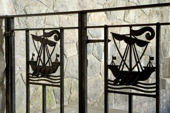 Interior. Detail of iron gates with ship motif at head of stair to undercroft.
