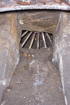 Interior. View looking up below rim spur gear and cast-iron wheel rim. Note the spokes of a flat belt drive pulley wheel located in the adjacent building (NE range).