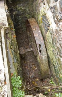 View of interior of N elevation of NE range,  detail of flat belt pulley wheel driven straight from the waterwheel small driven gear and rim gear. This pulley wheel would have been attached to the pulley wheel mounted above (see DP 035646).