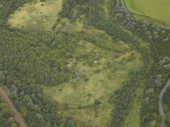 Oblique aerial view centred on the remains of an anti-aircraft battery, taken from the S.