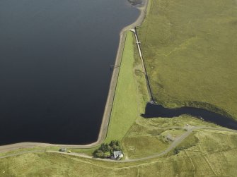 Oblique aerial view centred on W dam with cottage adjacent, taken from the NW.