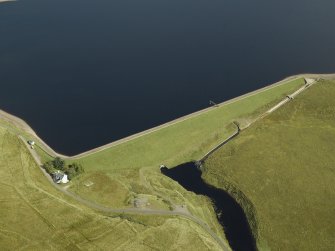 Oblique aerial view centred on W dam with cottage adjacent, taken from the SW.