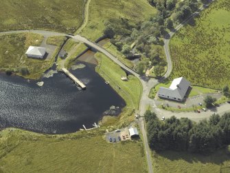 Oblique aerial view centred on the dam and sluice with bridge adjacent, taken from the NNW.