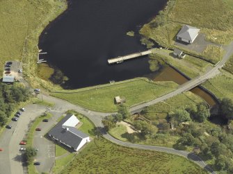 Oblique aerial view centred on the dam and sluice with bridge adjacent, taken from the WNW.