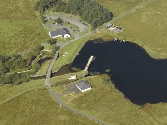 Oblique aerial view centred on the dam and sluice with bridge adjacent, taken from the SE.