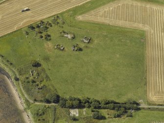 Oblique aerial view centred on the anti-aircraft battery with the remains of the farmstead adjacent, taken from the E.