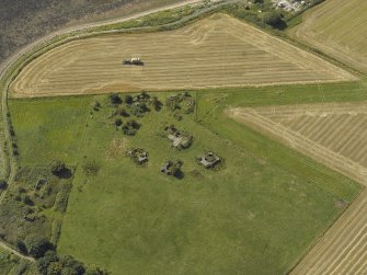 Oblique aerial view centred on the anti-aircraft battery with the remains of the farmstead adjacent, taken from the NE.