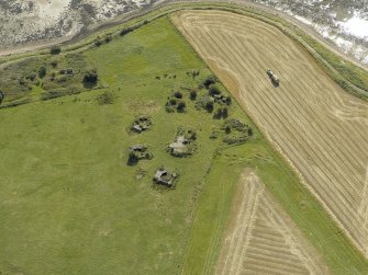 Oblique aerial view centred on the anti-aircraft battery with the remains of the farmstead adjacent, taken from the NNE.