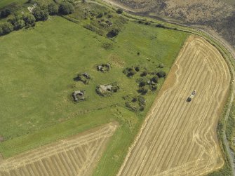 Oblique aerial view centred on the anti-aircraft battery with the remains of the farmstead adjacent, taken from the NNW.