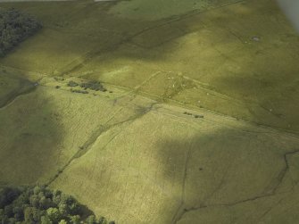 Oblique aerial view centred on the decoy site with a bomb crater adjacent, taken from the E.