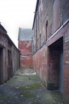 Hall entrance alley. View from SE