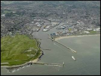 General oblique aerial view centred on the harbour, taken from the E.