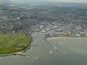General oblique aerial view centred on the harbour, taken from the ENE.