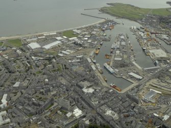 General oblique aerial view centred on the harbour, taken from the WNW.