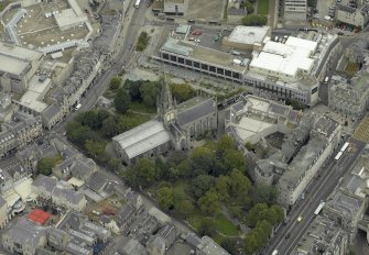 Oblique aerial view centred on the Church of St Nicholas with the St Nicholas Centre adjacent, taken from the SW.