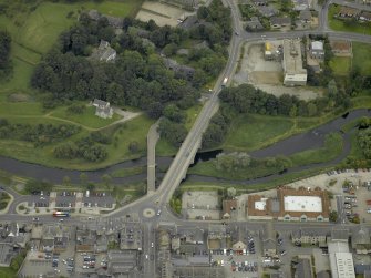 Oblique aerial view centred on the old and new bridges, taken from the NW.