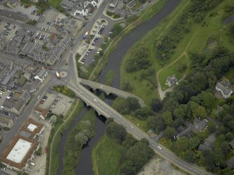 Oblique aerial view centred on the old and new bridges, taken from the SW.