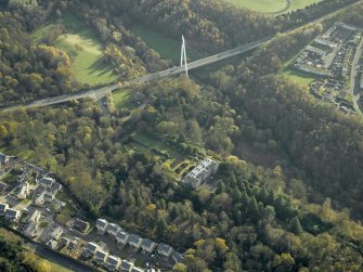 Oblique aerial view centred on the house with the bridge adjacent, taken from the NW.