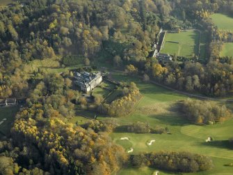 Oblique aerial view centred on the house with the walled garden and stables adjacent, taken from the WNW.