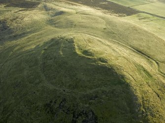 Oblique aerial view centred on the remains of the fort, taken from the NNW.