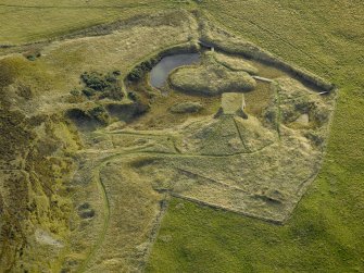 Oblique aerial view centred on the remains of the lime kiln, taken from the N.