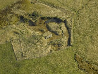 Oblique aerial view centred on the remains of the lime kiln, taken from the NW.